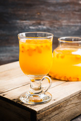 Hot buckthorn beverage in glass. Selective focus. Shallow depth of field. 