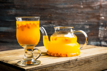 Hot buckthorn beverage in glass. Selective focus. Shallow depth of field. 