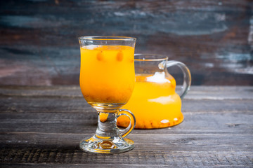 Hot buckthorn beverage in glass. Selective focus. Shallow depth of field. 