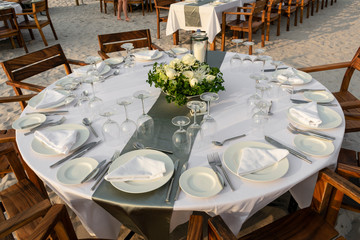 romantic wedding table design at sunset outside on asian beach