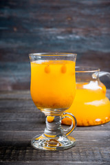 Hot buckthorn beverage in glass. Selective focus. Shallow depth of field. 