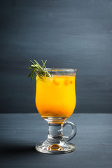 Hot buckthorn beverage in glass. Selective focus. Shallow depth of field. 