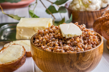 Buckwheat porridge with a piece of butter close up