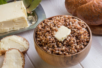 Buckwheat porridge with a piece of butter close up