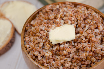 Buckwheat porridge with a piece of butter close up