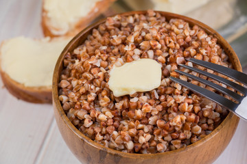 Buckwheat porridge with a piece of butter close up