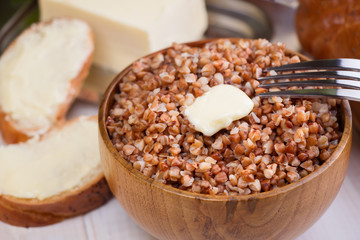 Buckwheat porridge with a piece of butter close up
