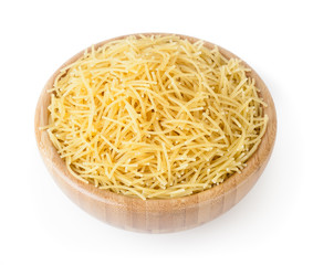 Uncooked vermicelli pasta in wooden bowl isolated on white background with clipping path