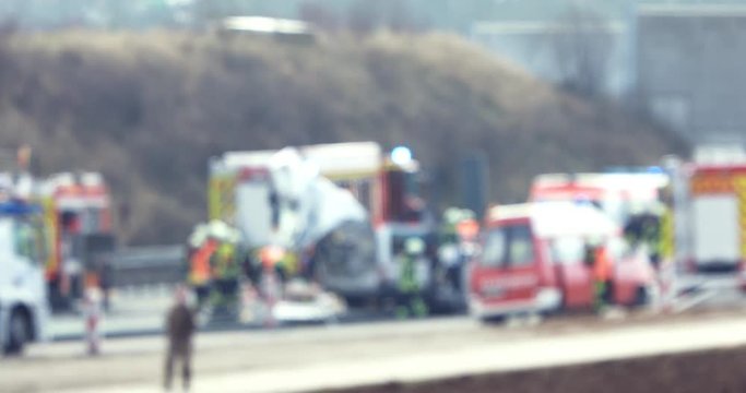 The blured view of paramedics and firemen providing first aid to victims in accident.