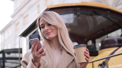 Stylish happy hipster girl using modern smartphone device.