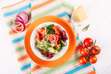 Fresh Healthy Red Vegetable Spring Salad Top View. Gourmet Mediterranean Green Raw Food Appetizer with Onion, Pepper and Cucumber Ingredient Flat Lay. Organic Vegetarian Lifestyle with Herbal Diet
