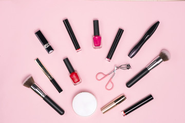 Make up or visage background. Female bag and different make up accessories, brushes, lipstick, and pencils.