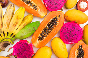 Fruits background of banana, papaya, mango and dragon fruits. Flat lay. Top view. Tropical concept