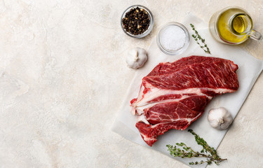 Fresh beef meat on white background with olive oil, herbs and spices