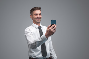 Smiling businessman with smartphone