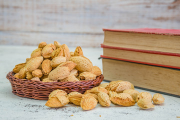 Delicious almonds nut with shell on wood background