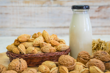 Arrangement of dried fruits almonds and walnuts on rustic old wooden table