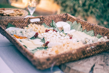 table of different cheeses in an outdoor catering cocktail