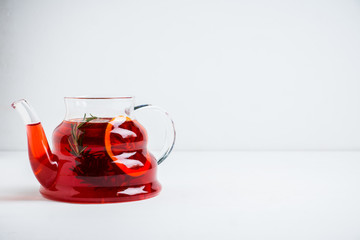 Fruit drink based on raspberry with red orange slice in glass teapot. Selective focus. Shallow depth of field.
