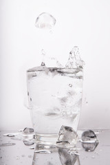 glass of water with ice and cubes isolated on white background