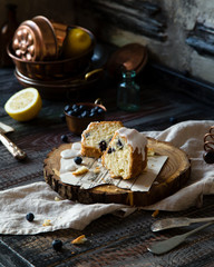 Slices of homemade delicious bundt cake with white glaze on top on wooden stand