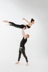 Modern Ballet Dance Couple High Level Lift Pose. Man in Stand, Hold Young Woman Dancer with Two Hand. Caucasian Brunette Skinny Girl Perfomer Flying Position Isolated on White Background