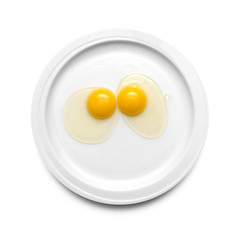 Two chicken egg yolks on a plate