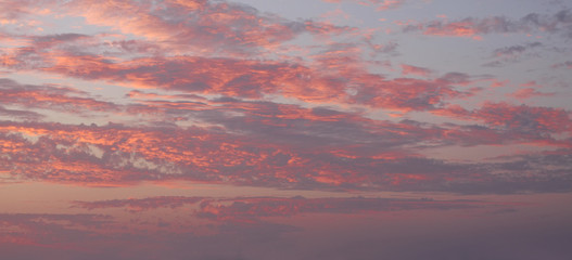Blue sky red clouds background. Beautiful landscape with clouds on sky