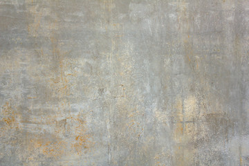 old dirty concrete wall with white and yellow spots of paint and scratches. rough surface texture