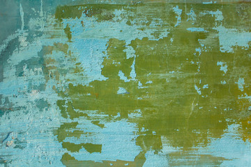 old shabby blue green wall with cracks and scratches. rough surface texture