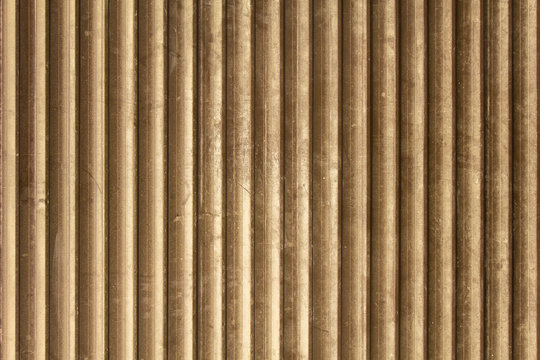 old gray brown dirty dusty metal wall of the louver with vertical lines. rough surface texture