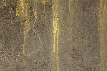 old gray concrete wall with deep relief, scratches and light paint stains. rough surface texture