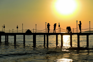 view of seaside and pier at sunset time