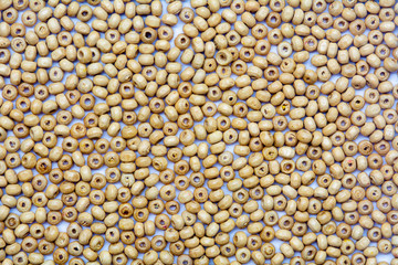 abstract background beautiful top view light colors small wooden beads