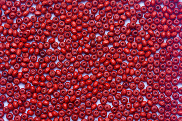 abstract background beautiful top view red colors small wooden beads