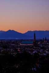 wide panorama during the sunset of the city of Vicenza and the famous monument called Basilica Palladiana with the tall Clock Tower. Vicenza, Veneto, Italy - April 2019