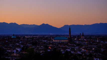wide panorama during the sunset of the city of Vicenza and the famous monument called Basilica Palladiana with the tall Clock Tower. Vicenza, Veneto, Italy - April 2019