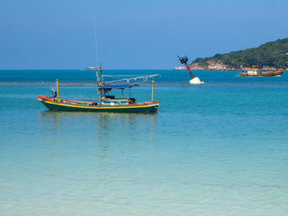 Naklejka na ściany i meble Motor boat on the surface of the sea near the island. Koh Phangan. Thailand