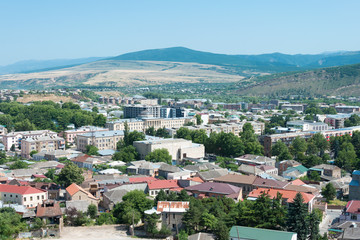 Fototapeta na wymiar Gori, Georgia - Jul 04 2018: Gori City view from Ruins of Gori fortress in Gori, Shida Kartli, Georgia.