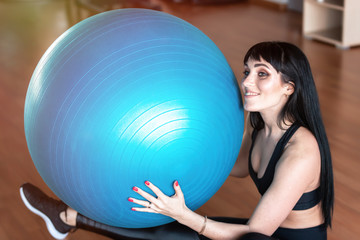 Fototapeta premium Fitness woman exercise with ball in gym. Individual sport to fit muscles of body for healthy life concept.