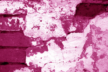Old grungy brick wall texture in pink tone.