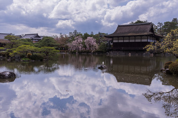 Traditional historical shrine Heian Shrine is reflected on the pond. Kyoto, Japan