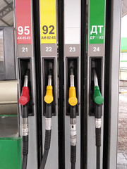 Fuel dispenser and nozzle, refueling car at the pump in a gas station. Car fueling petrol at gas station. Vehicle at fuel station, close-up of fuel pump.