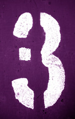 Number 3 in stencil on metal wall in purple tone.