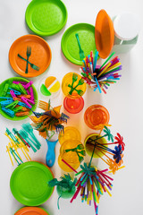 Transparent disposable cheap tools and utensils placed on white surface