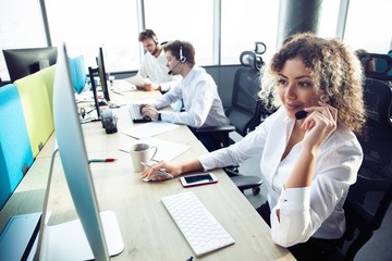Female customer support operator with headset and smiling
