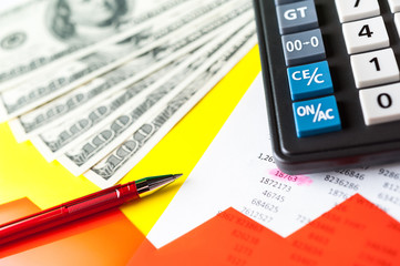 Obraz premium Business and financial background with dollars, data, pen and calculator. Bookkeeping background.