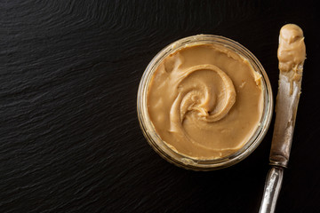 Peanuts and Fresh Peanut Butter Isolated Black Background Protein Super Food Snack with copy space