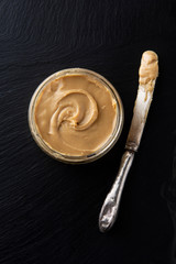 Peanuts and Fresh Peanut Butter Isolated Black Background Protein Super Food Snack with copy space