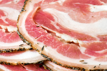 Tasty sliced lard, pork bacon, meat, jamon, prosciutto on white background, close up